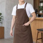 Tạp dề đồng phục dây đeo chữ X màu nâu cà phê, vải kaki thun, túi đôi phía trước
